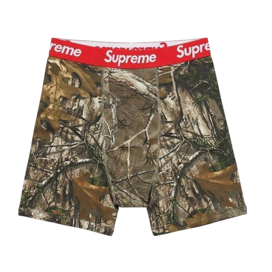 vsresell Supreme Hanes boxer briefs in Real Tree camo print with a red elastic waistband featuring white logo text.